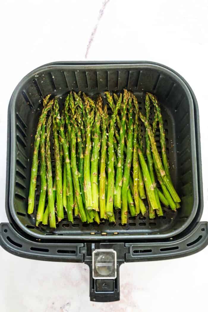 simple roasted asparagus in an air fryer basket