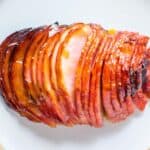 meat fork in sliced of glazed boneless ham