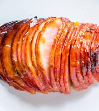 meat fork in sliced of glazed boneless ham