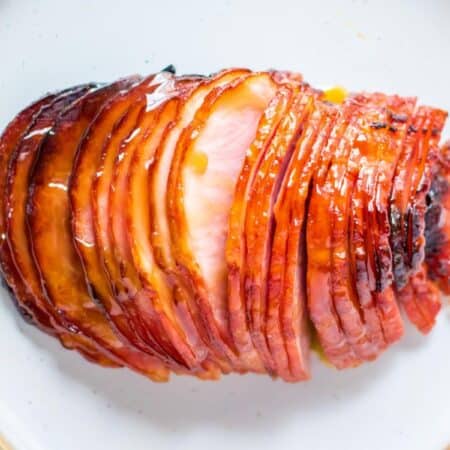 meat fork in sliced of glazed boneless ham