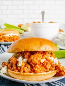 Buffalo chicken sandwich on a plate with blue cheese.