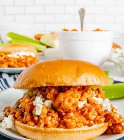 Buffalo chicken sandwich on a plate with blue cheese.