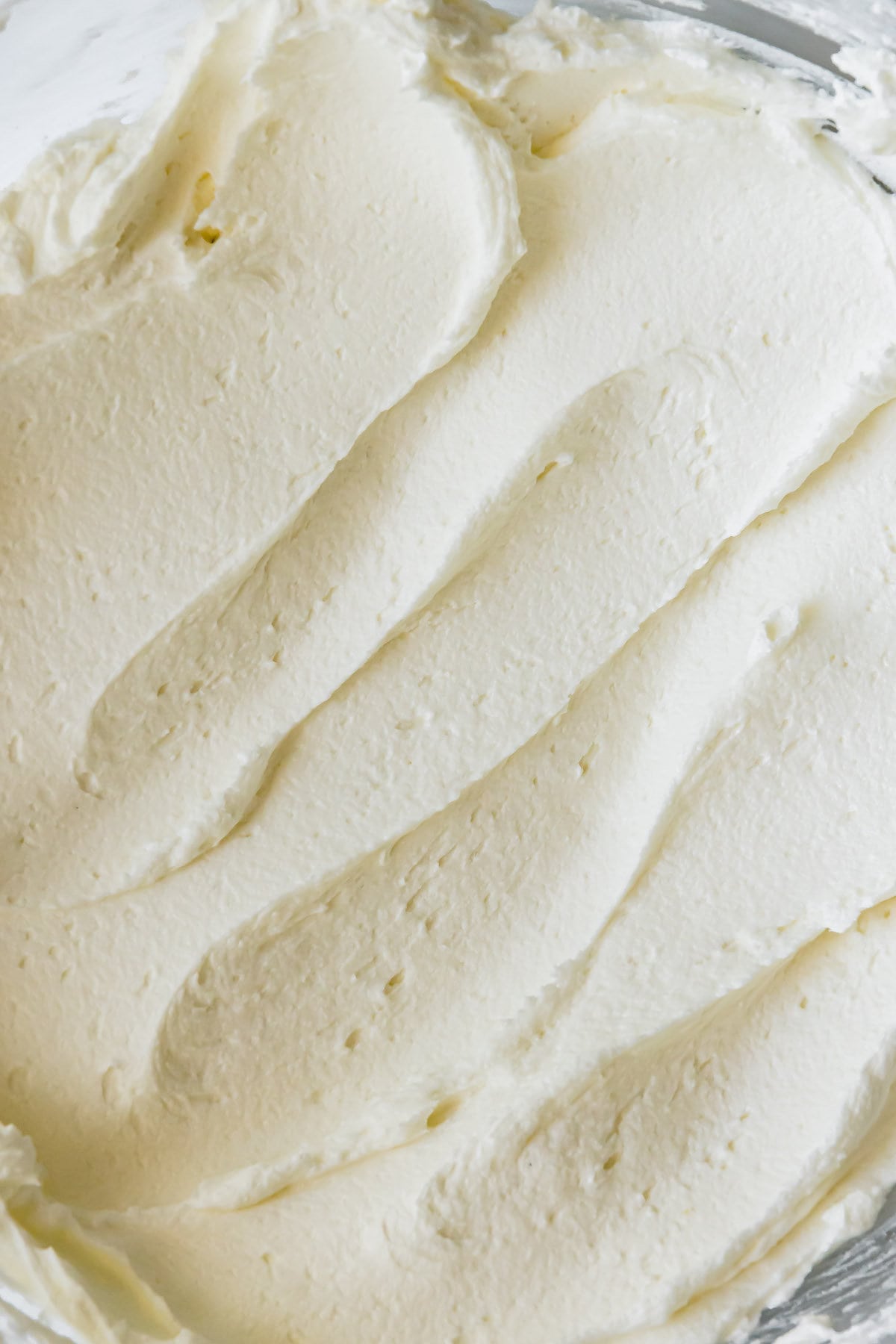 A Close-Up Image of Vanilla Buttercream Frosting in a Mixing Bowl.