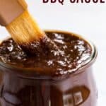 brush dipping into a jar of barbecue sauce