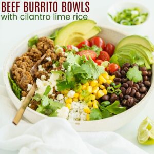 ground beef burrito bowl with lime wedge and bowl of scallions on the side