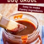 brush dunked into ajar of homemade barbecue sauce