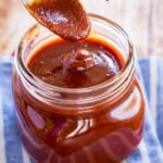 bourbon barbecue sauce dripping off of a spoon into a jar