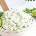 white rice with cilantro and lime in a white bowl with a blue decoration