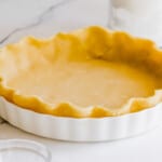 pie dough pressed into a white pie plate