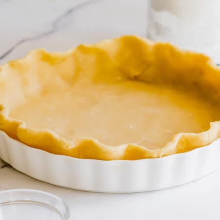 pie dough pressed into a white pie plate