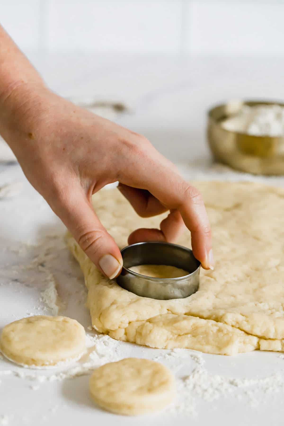 A Cookie Cutter Being Used to Shape Biscuits from the Dough