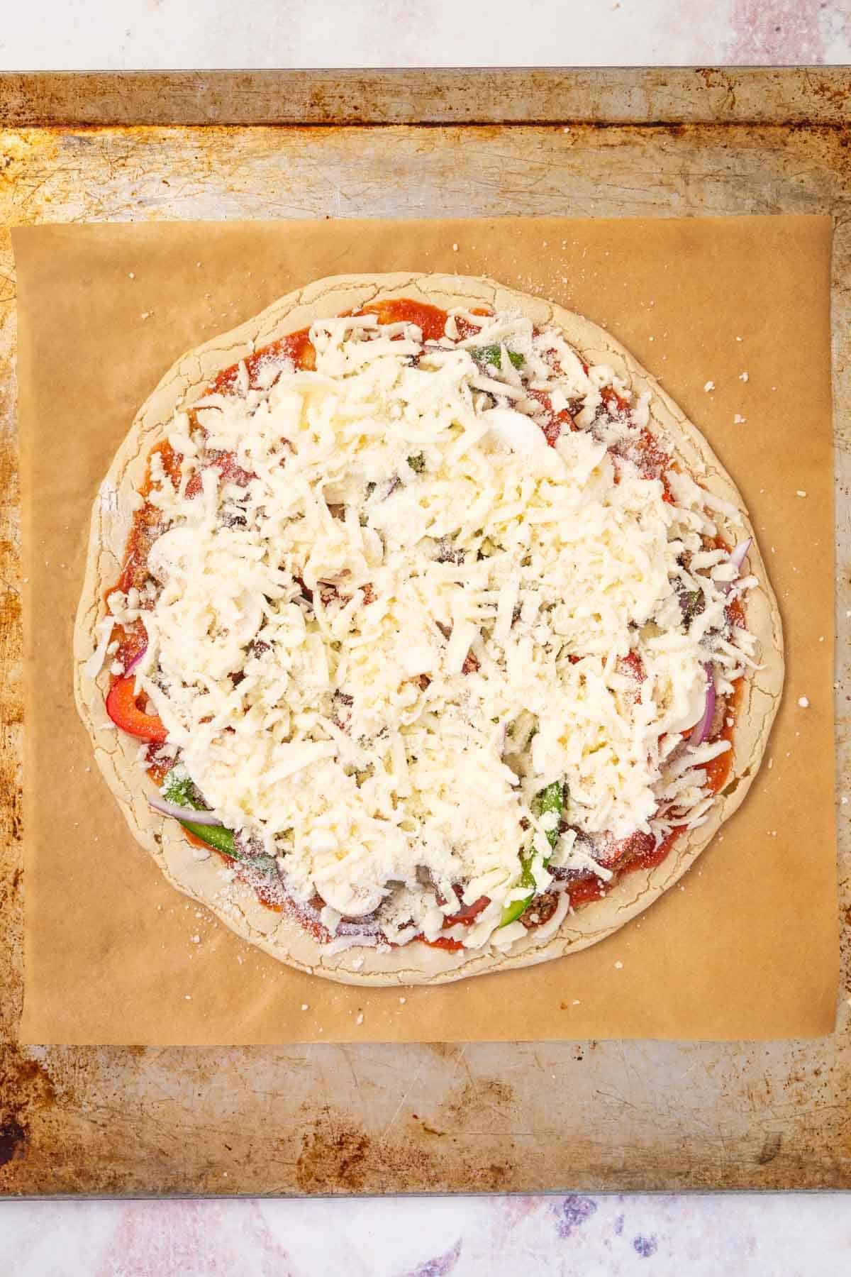 The Cheese on Top of the Veggies, Meat, Sauce and Crust of a Supreme Pizza