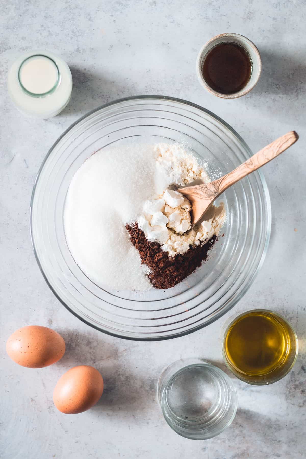 Sugar, Gluten-Free Flour, Cocoa Powder and the Other Dry Ingredients in a Glass Mixing Bowl
