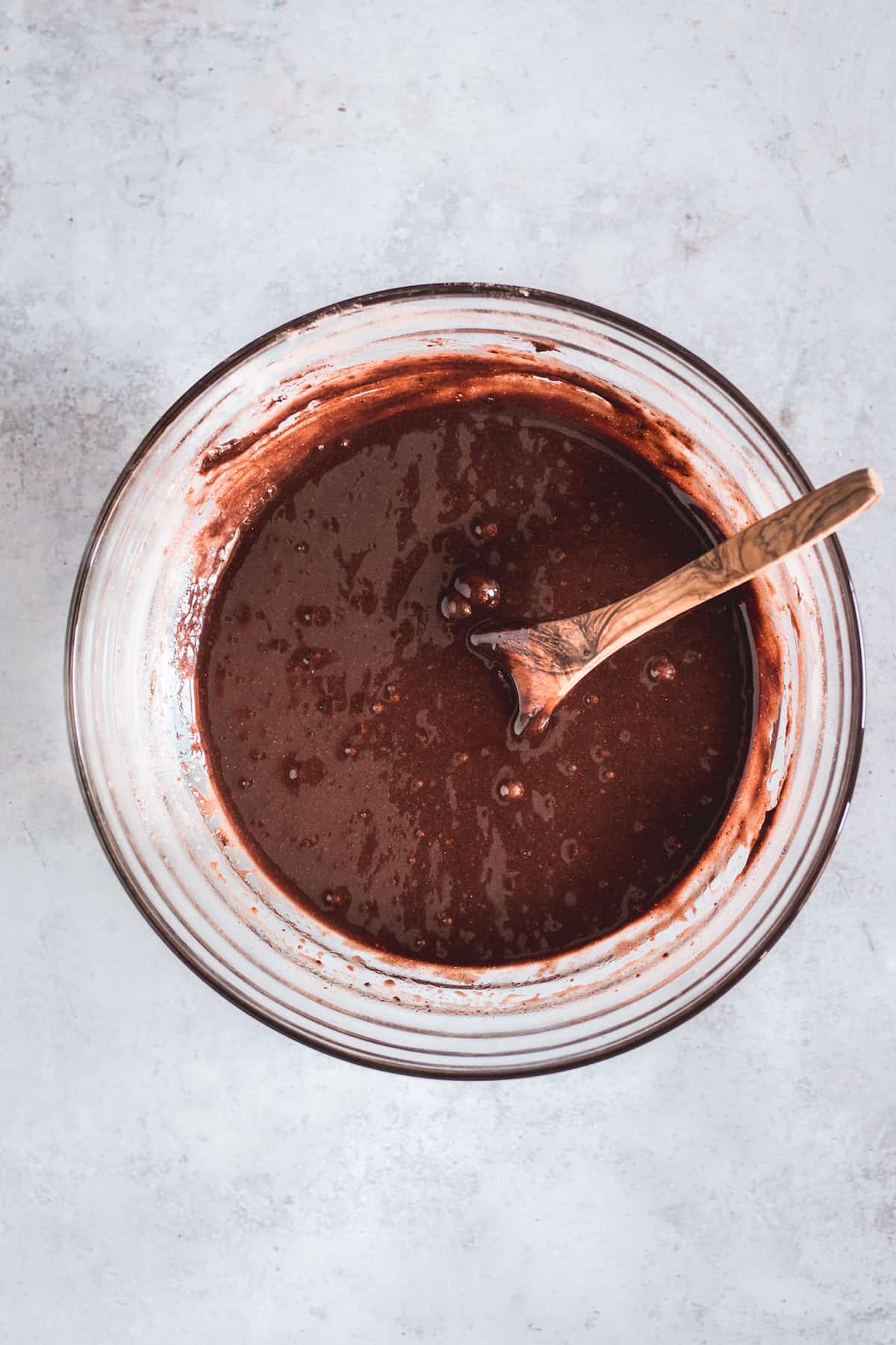 Finished Gluten Free Chocolate Cupcake Batter in a Mixing Bowl with a Wooden Spoon