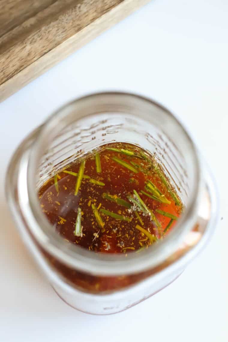 looking into the top of a jar with the vinaigrette ingredients