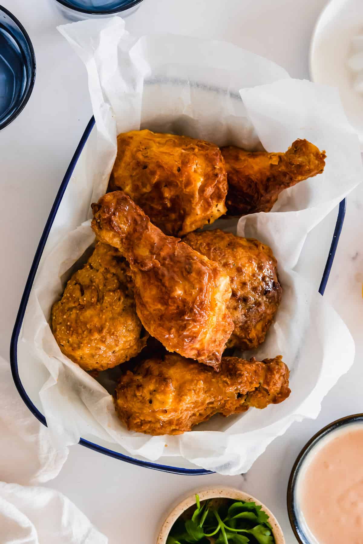 A Bowl of Gluten-Free Fried Chicken with a Parchment Liner Between the Bowl and the Meat