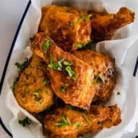 Six Pieces of Fried Chicken in a Serving Bowl Lined with Parchment Paper