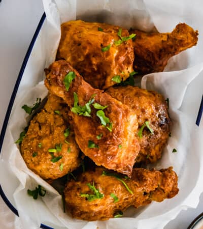 Six Pieces of Fried Chicken in a Serving Bowl Lined with Parchment Paper