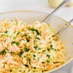 A Close-Up Shot of Homemade Coleslaw in a Bowl with Two Spoons