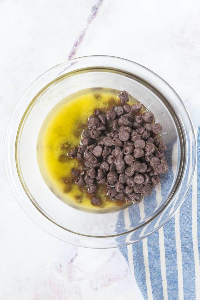melted butter and chocolate chips in a glass bowl