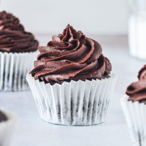 several chocolate cupcakes scattered on a table
