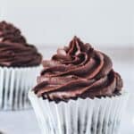 One chocolate cupcake with chocolate frosting in the center with text overlay that says "Gluten Free Chocolate Cupcakes".