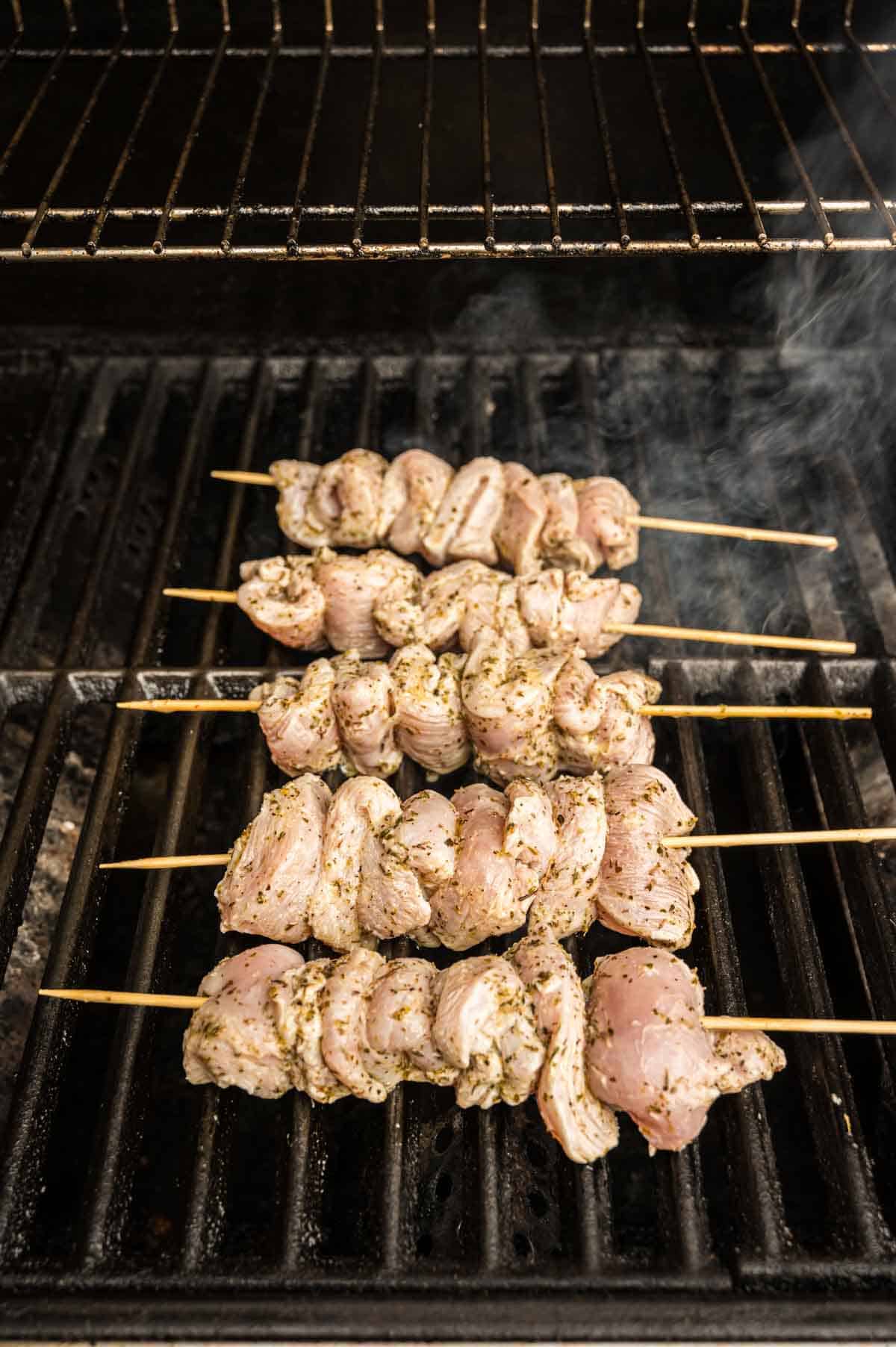 Five Greek Chicken Skewers Smoking Away on a High-Heat Grill
