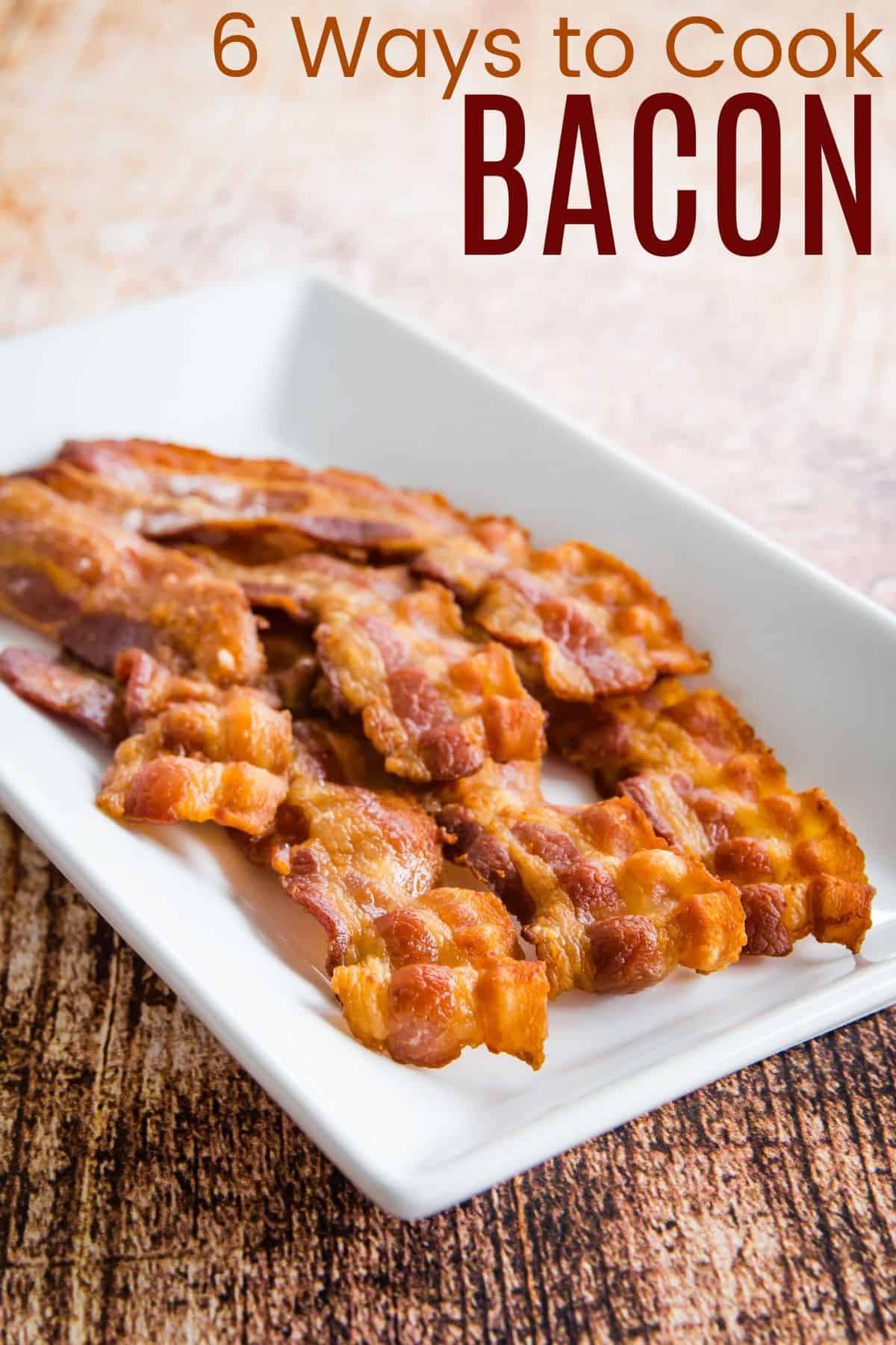 six crispy slices of cooked bacon on a white rectangular plate
