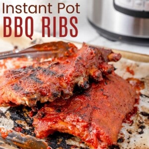 two racks of barbecue ribs on a baking sheet in front of an Instant Pot