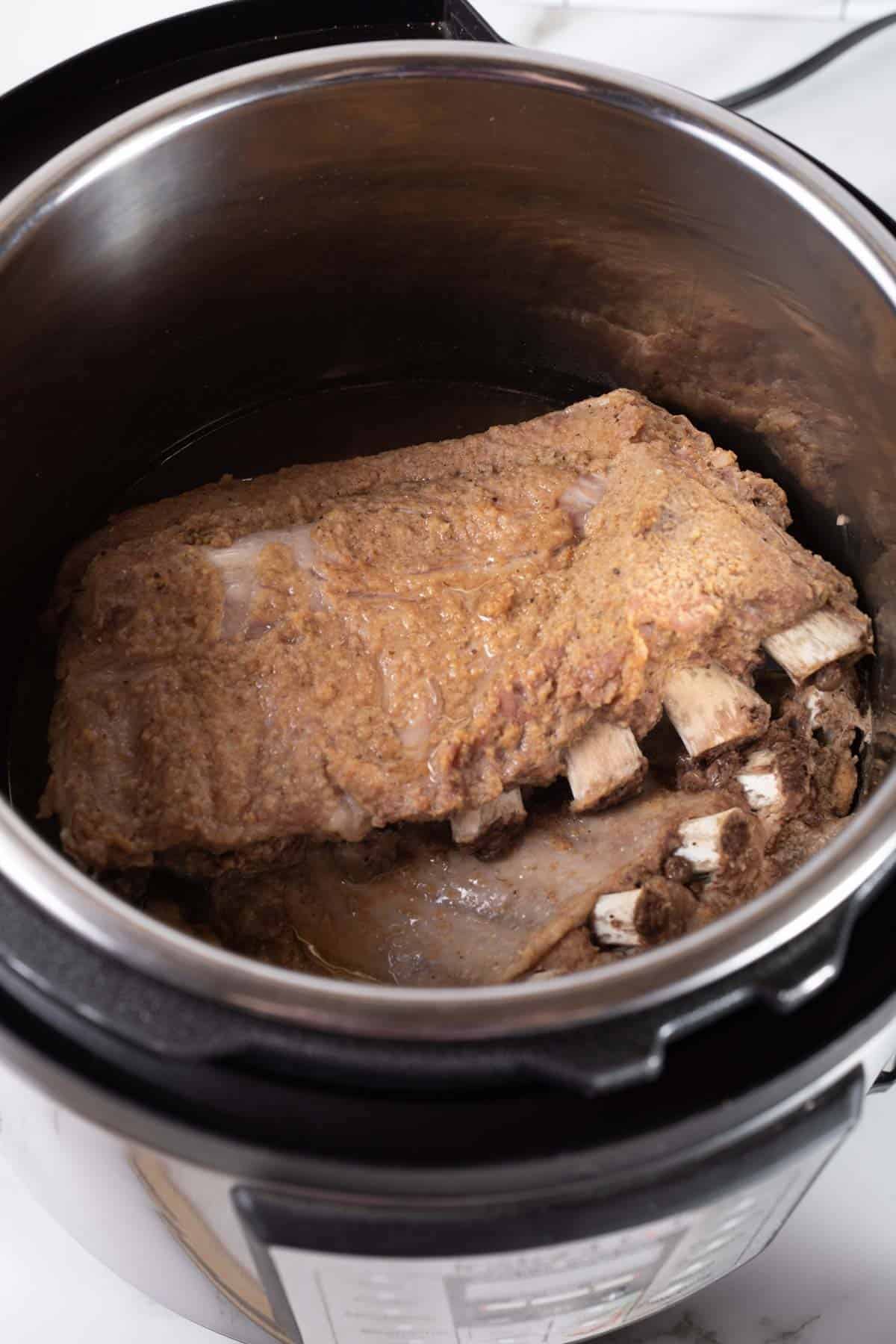 Two Cooked Sets of Ribs in the Inner Pot of an Instant Pot