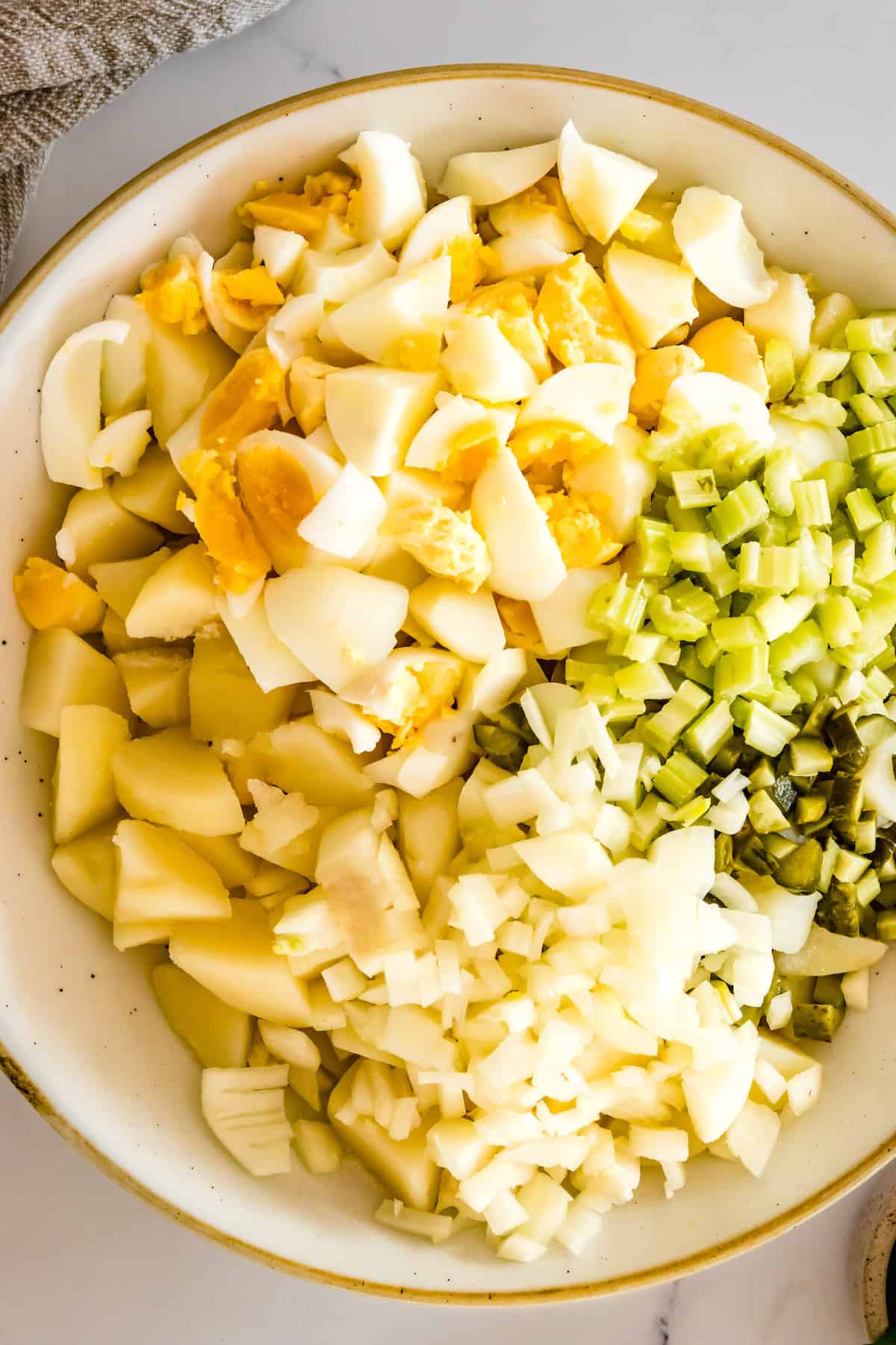 Chopped Hard Boiled Eggs, Chopped, Peeled and Cooked Potatoes Along with the Diced Vegetables in a Large Bowl
