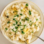 The Bird's-Eye View of a Plate of Potato Salad with Two Forks Digging in