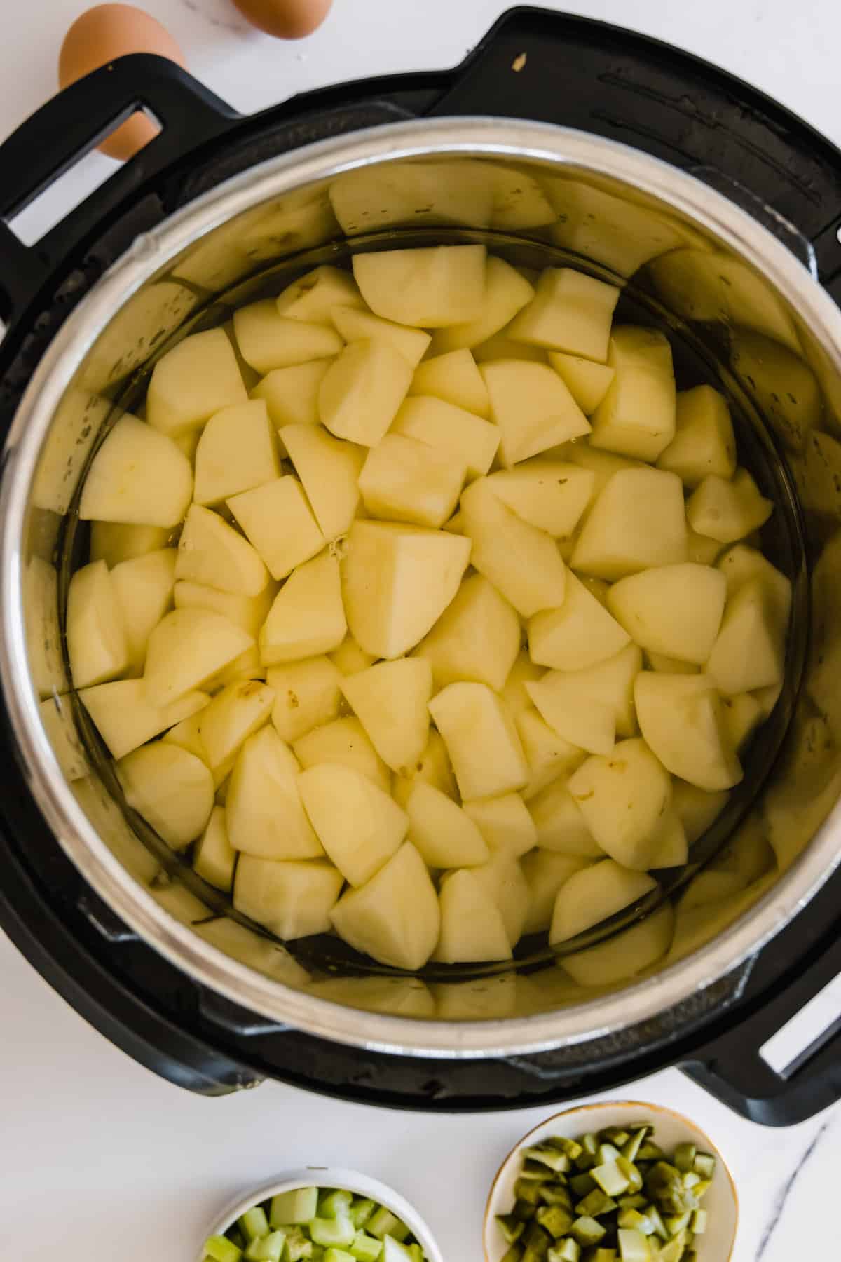 Chopped, Peeled Potatoes Inside of an Instant Pot on a Countertop
