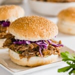 barbecue pulled pork sandwiches on sesame seed rolls