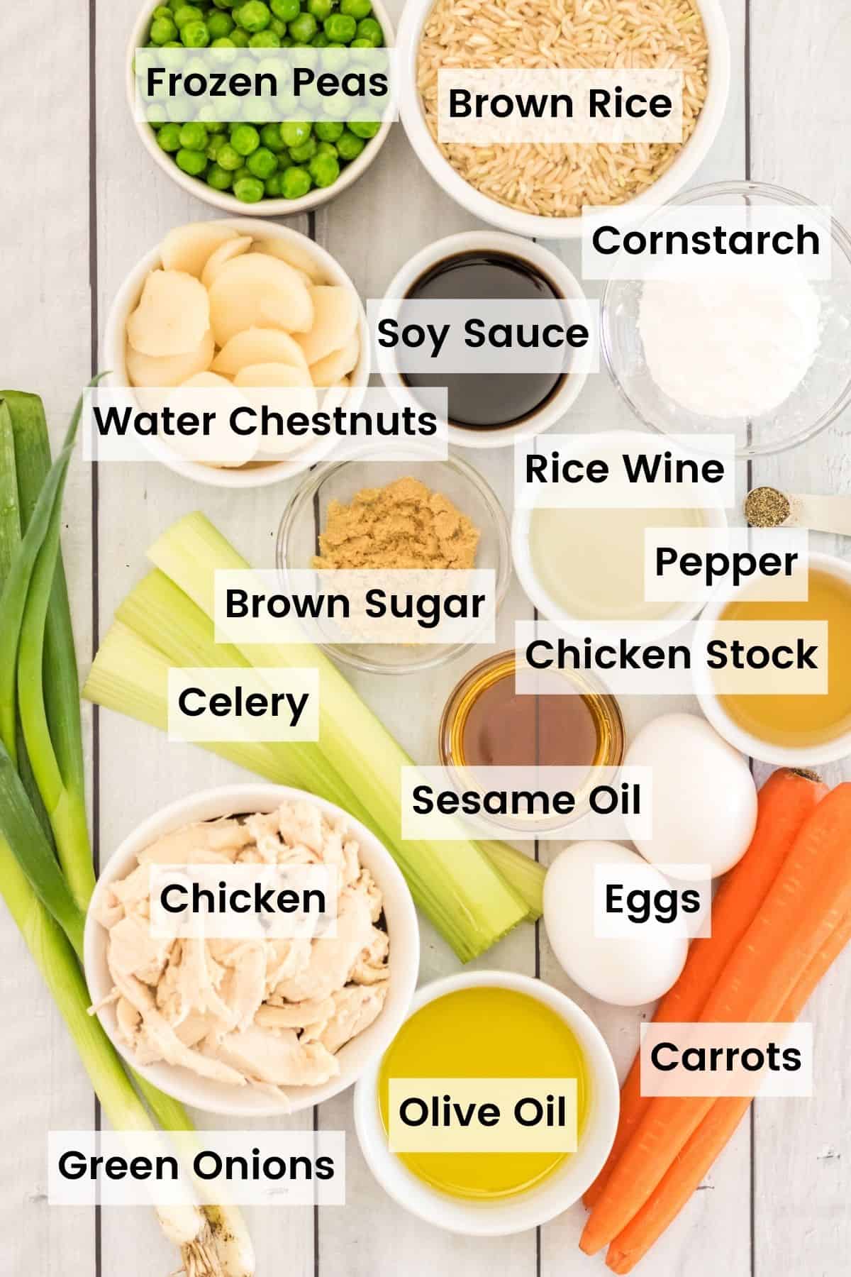 ingredients for chicken fried rice, incluidng shredded chicken, peas, carrots and water chestnuts