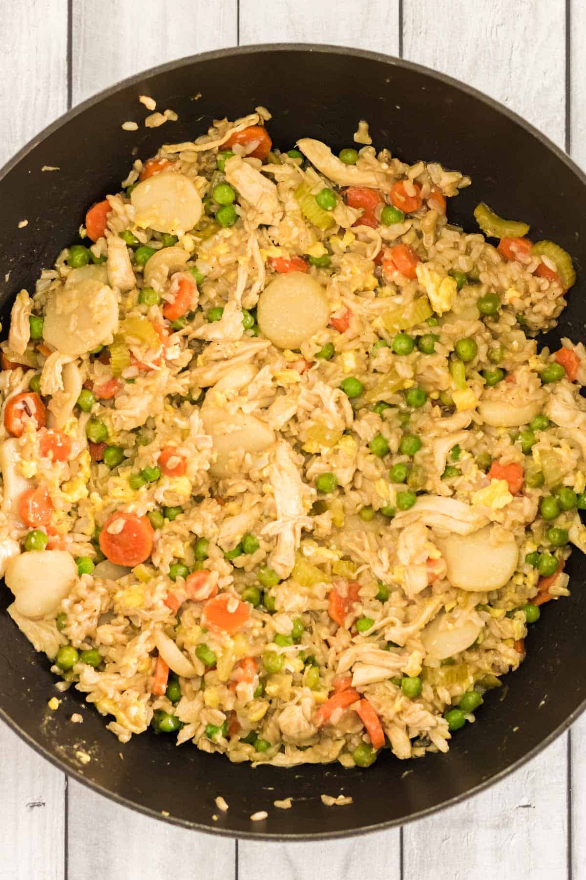 finished chicken fried rice in a large skillet with cooked eggs
