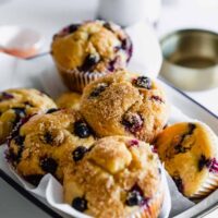 A White Serving Platter with a Blue Rim Containing Gluten-Free Blueberry Muffins