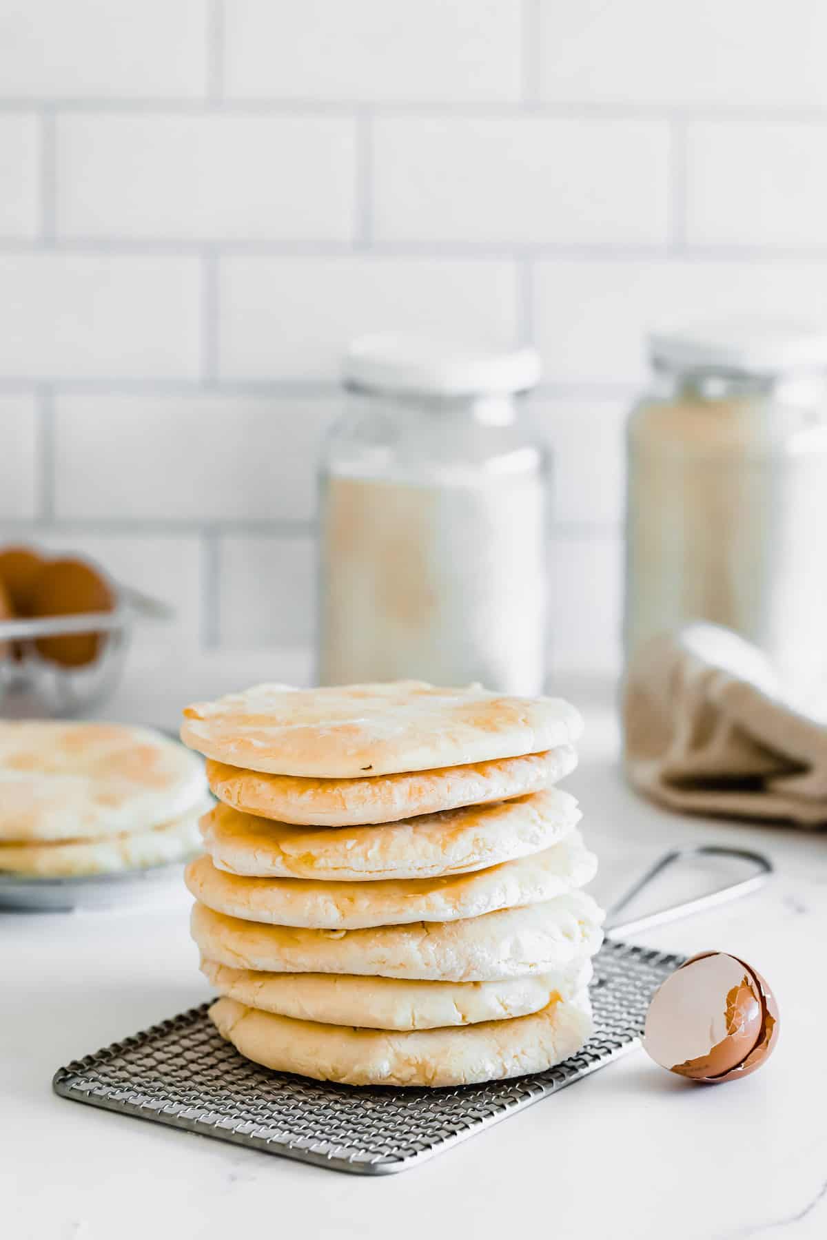 A Stack of Seven Circles of Gluten Free Pita Bread on Top of a Small Wire Rack