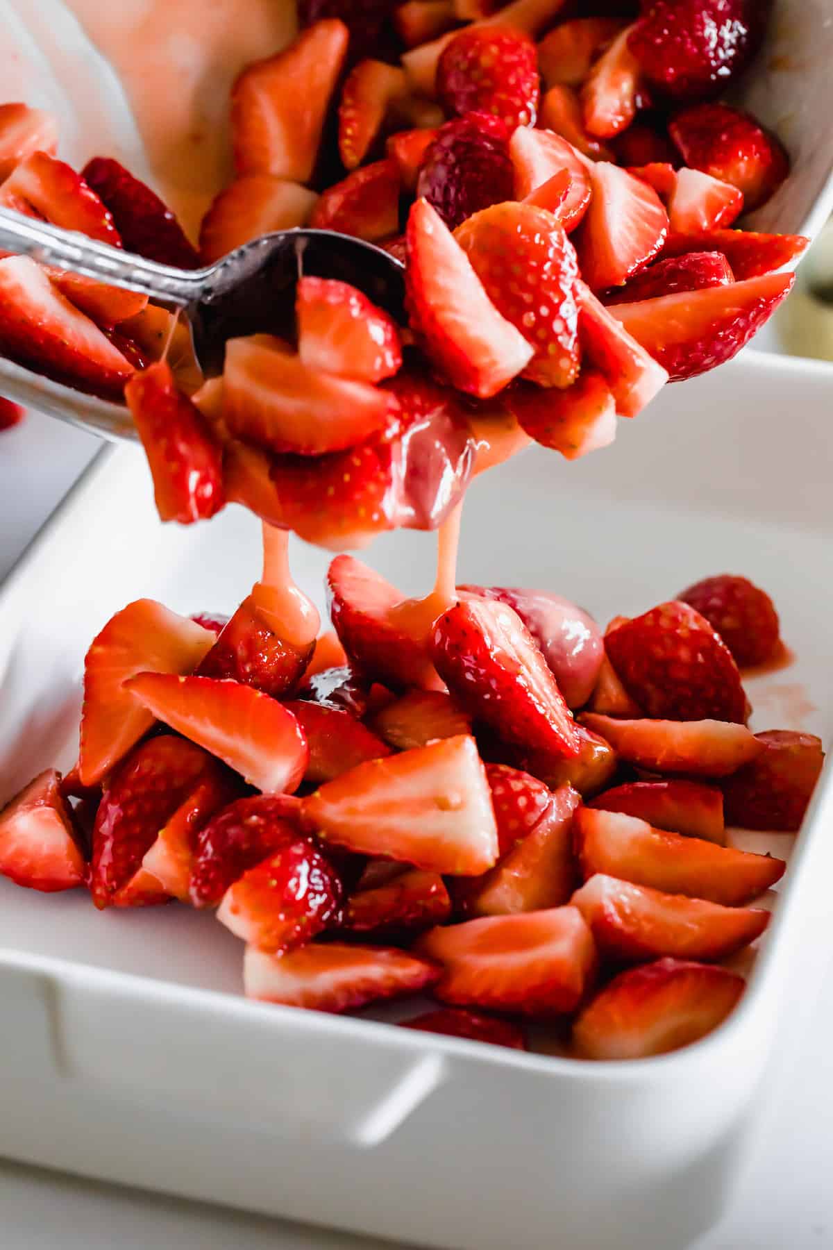 Strawberry Filling Being Poured From a Bowl Into a Baking Pan