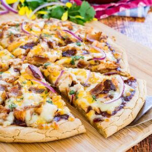 bbq chicken pizza on a wooden cutting board