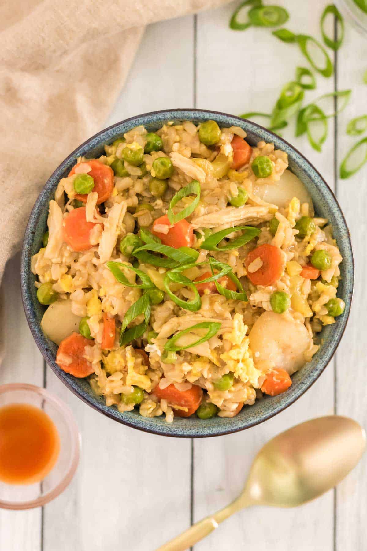 bowl of chicken fried rice with carrots, brown rice and shredded chicken