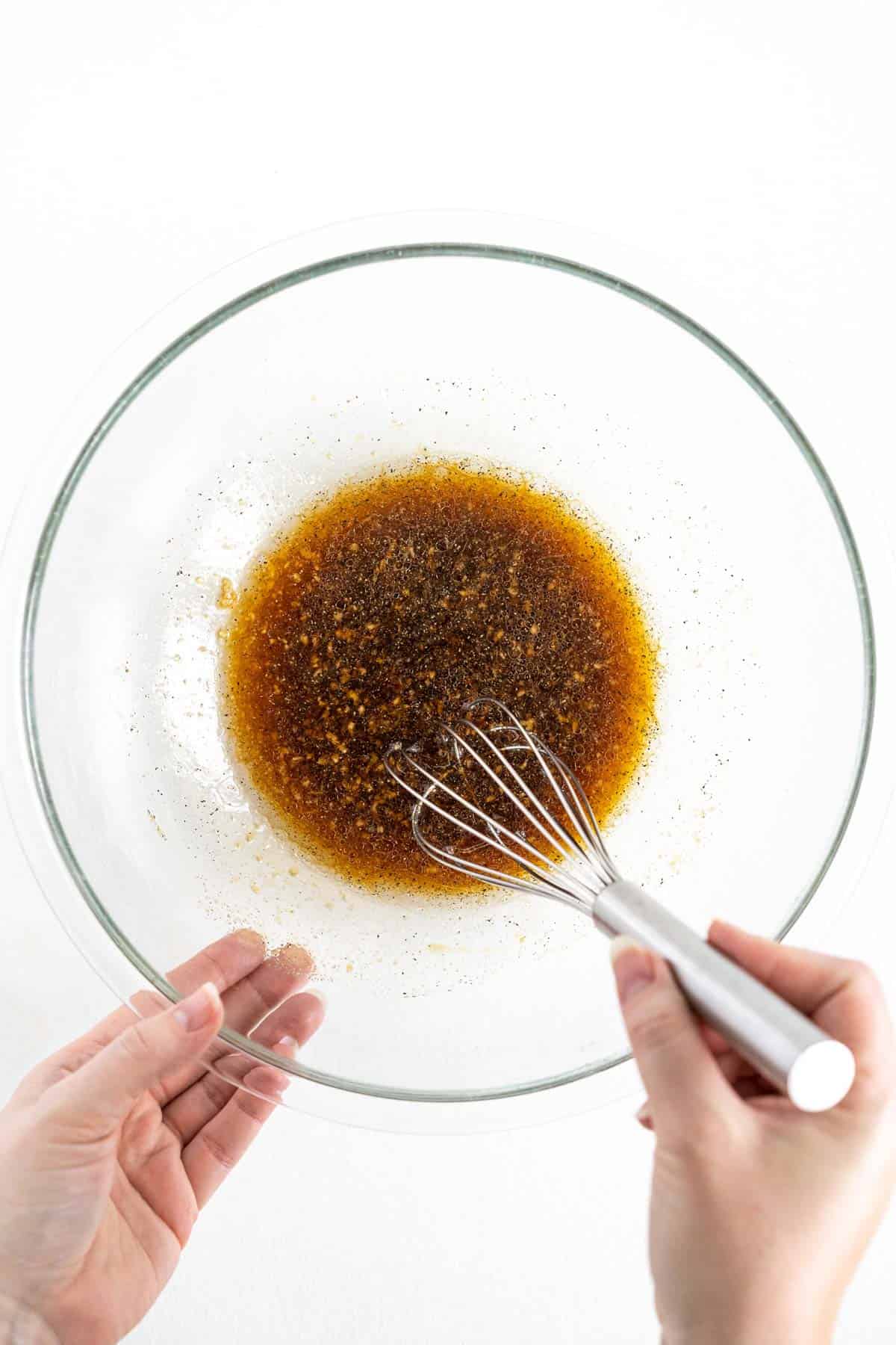 teriyaki sauce in a glass bowl with a metal whisk