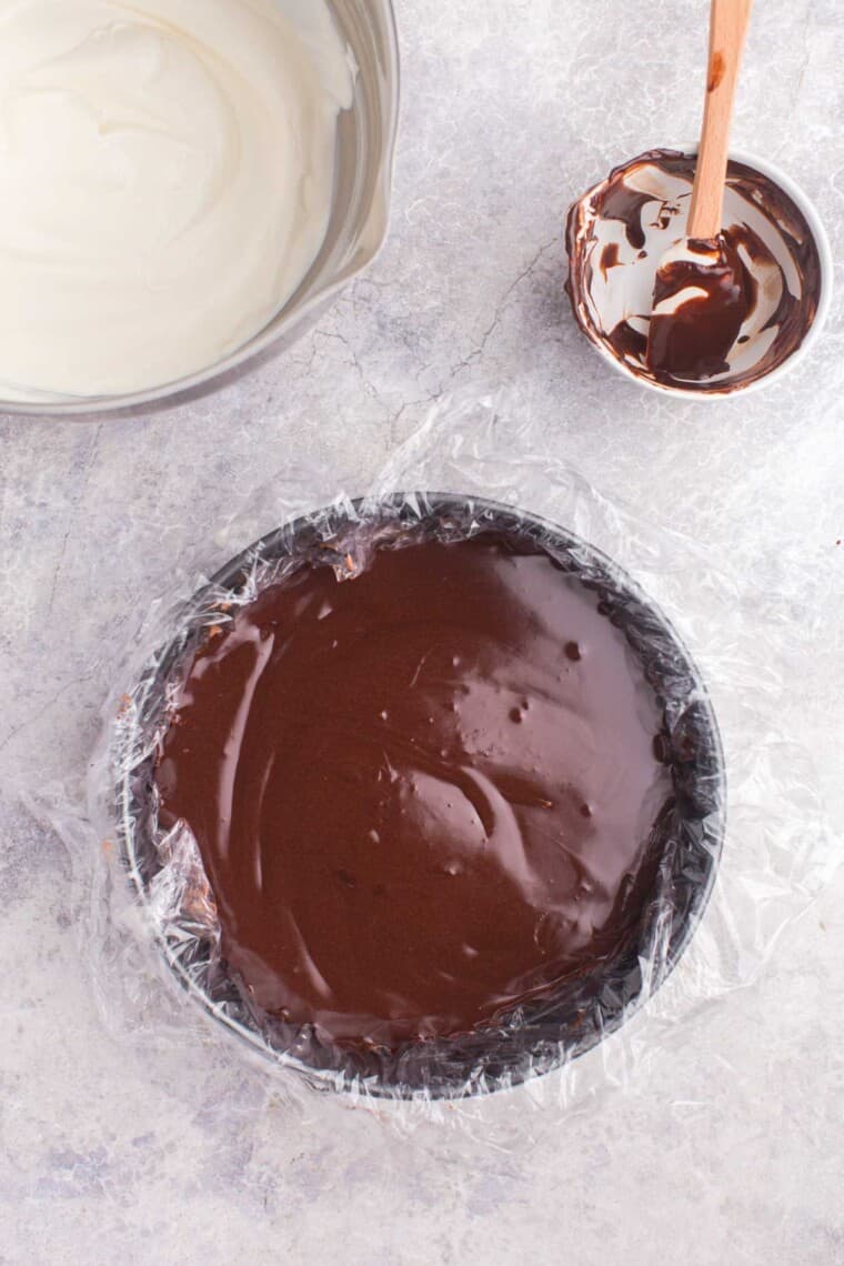 fudge sauce spread into the springform pan on top of the chocolate layer
