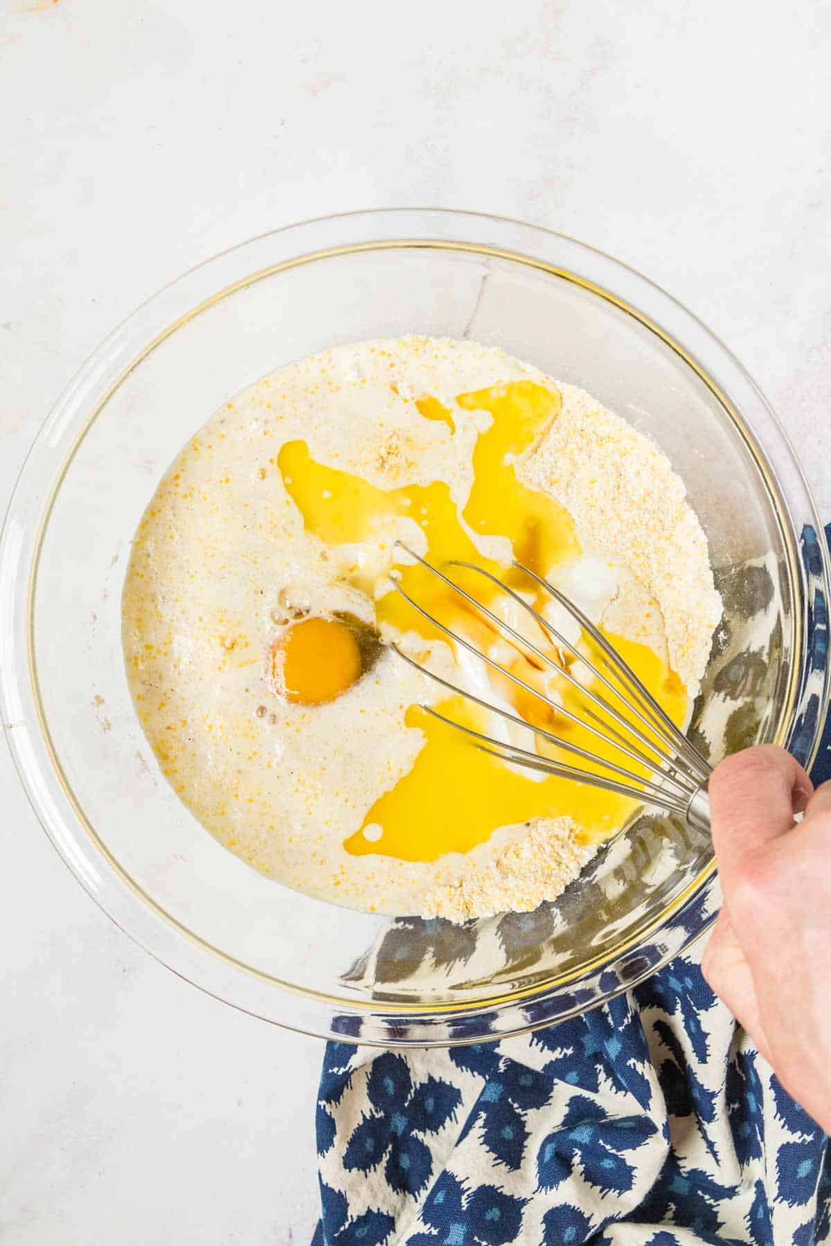 mixing wet and dry ingredients in a glass mixing bowl