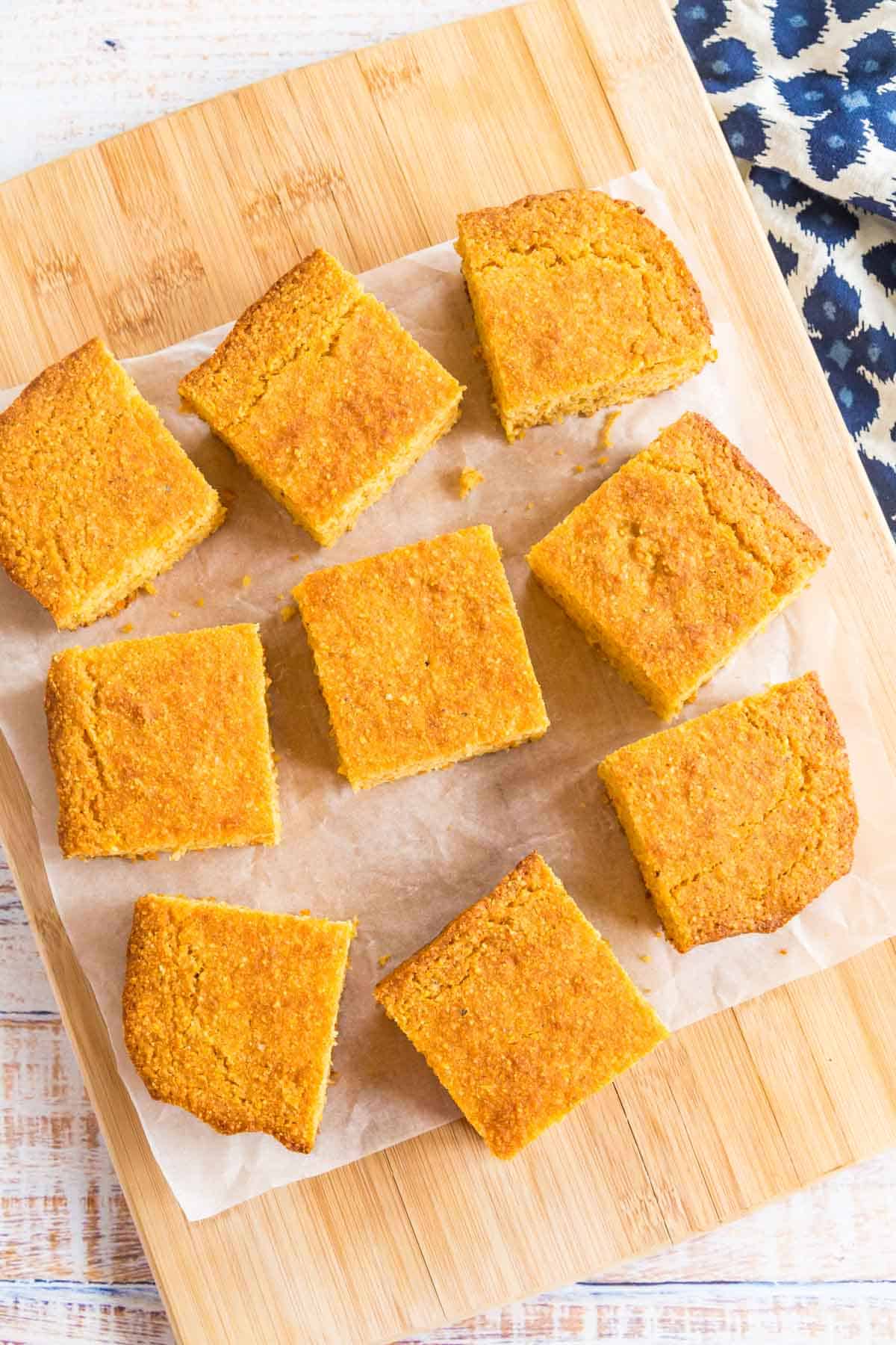 overhead of slices of cornbread on a piece of parchment paper