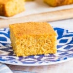 a piece of gluten free cornbread on a blue and white plate