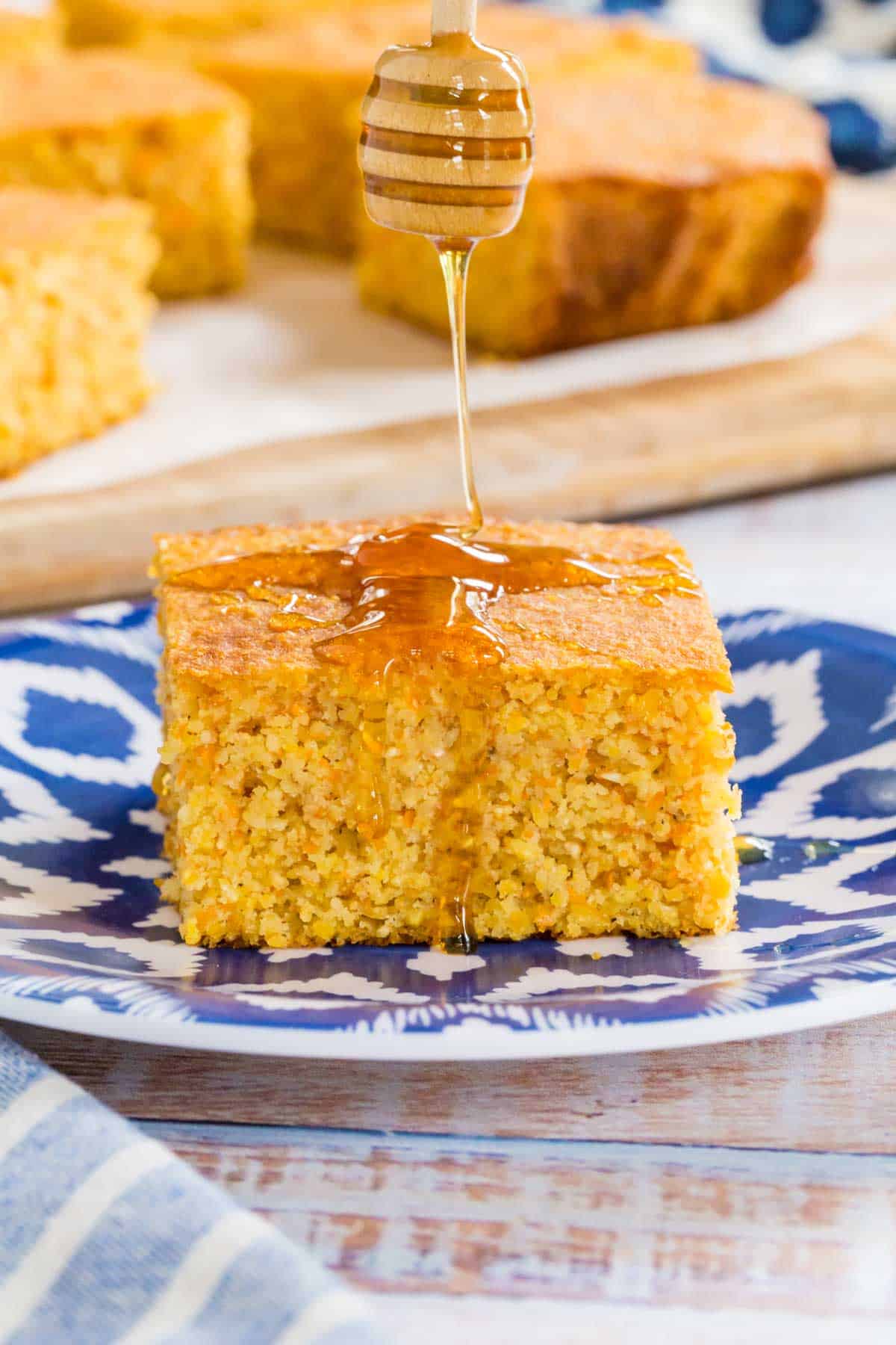 drizzling honey on a slice of cornbread