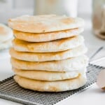 a stack of pita bread on a cooling rack