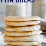 homemade pita bread in a stack on a cooling rack
