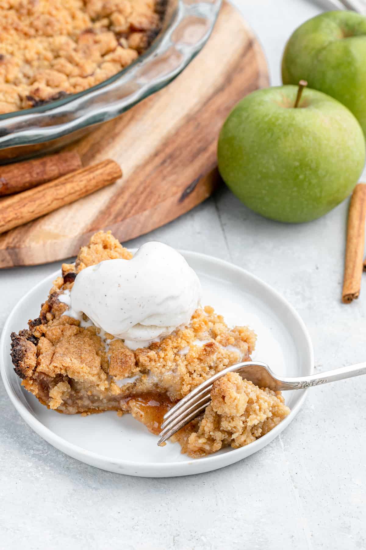slice of gluten-free apple pie with vanilla ice cream on top